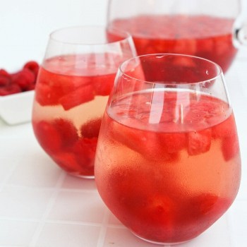 Short glasses with watermelon raspberry sangria on a table.