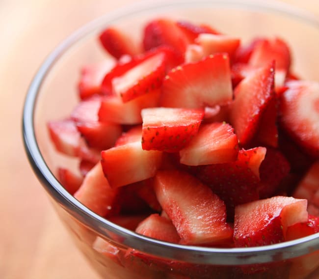 Bowl full of sliced strawberries