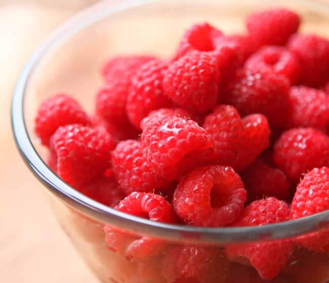 Bowl full of red raspberries