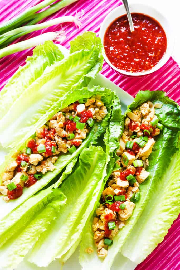 3 lettuce leaves used as a cup for chicken filling to make a healthier chicken wrap. 