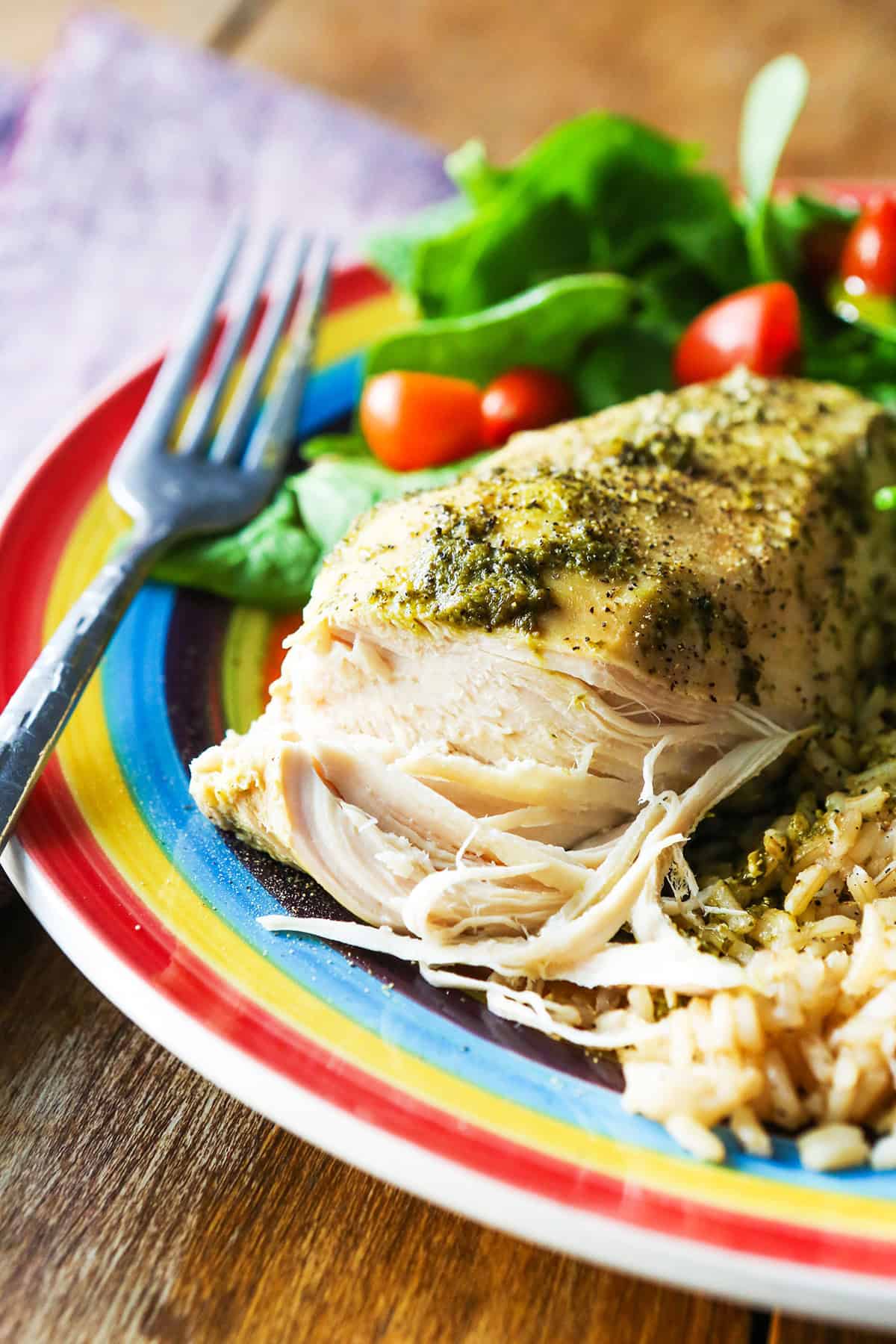 Tender meat exposed, revealing the inner part of a cooked pesto chicken breast.