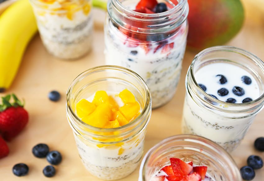 top view of mason jars filled with oatmeal and colorful fresh fruit