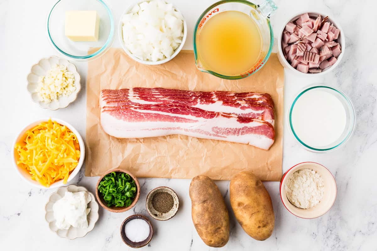 Ingredients for loaded potato soup lined up on a white counter.