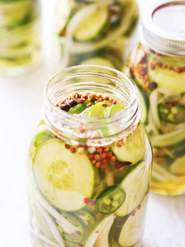 sliced pickles in a large mason jar