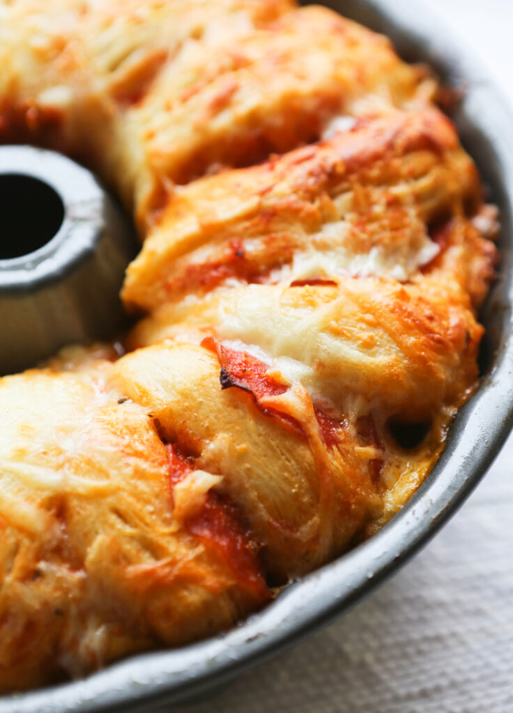 Bundt pan with baked pull apart pizza.