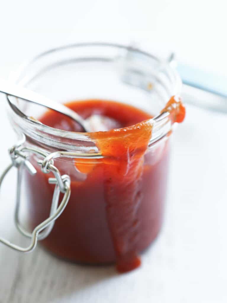 Arby's sauce in a glass jar with drips running down sides