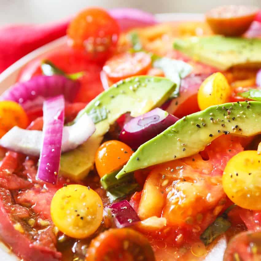 Tomato, avocado and onion salad close up. 