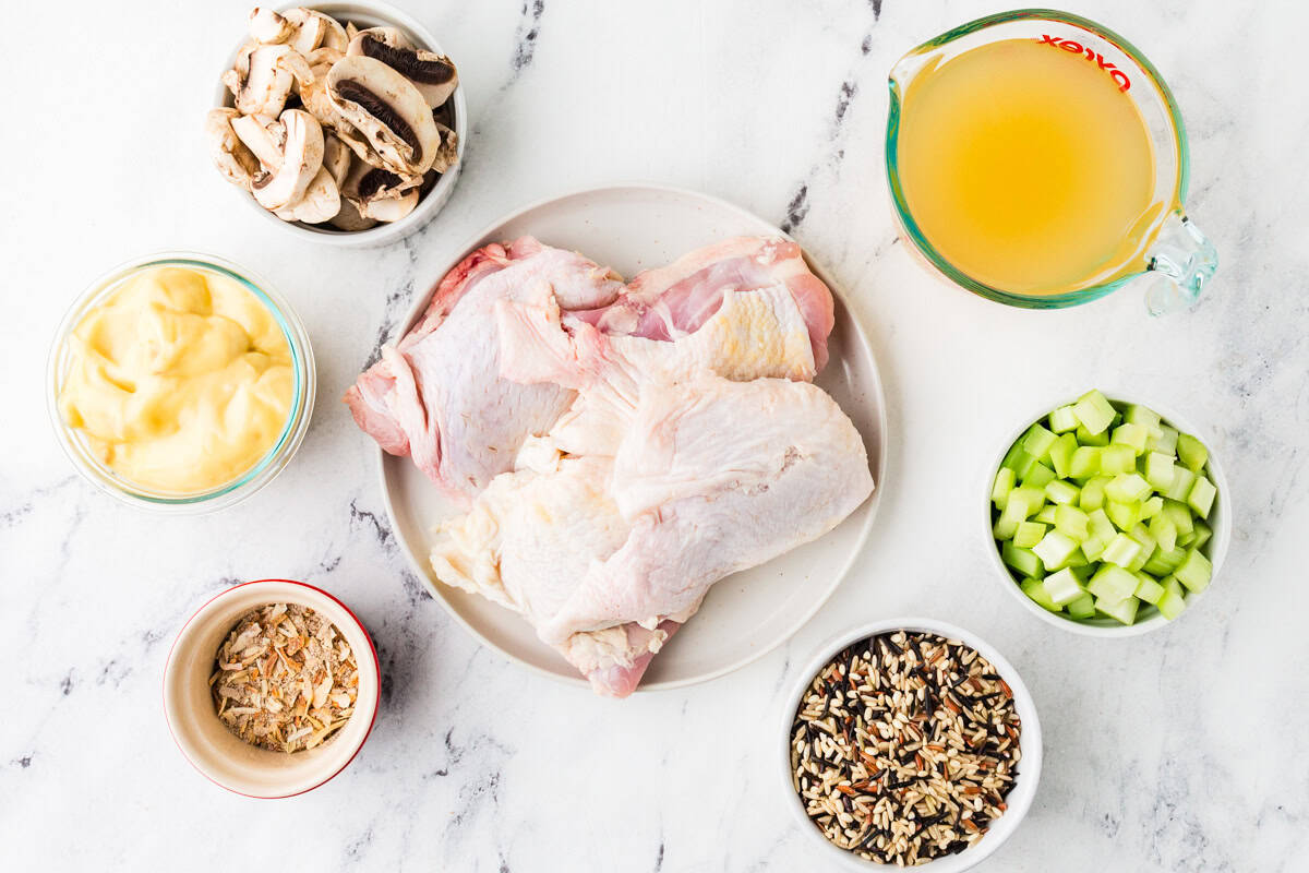 Ingredients for chicken rice bake on a white counter top.