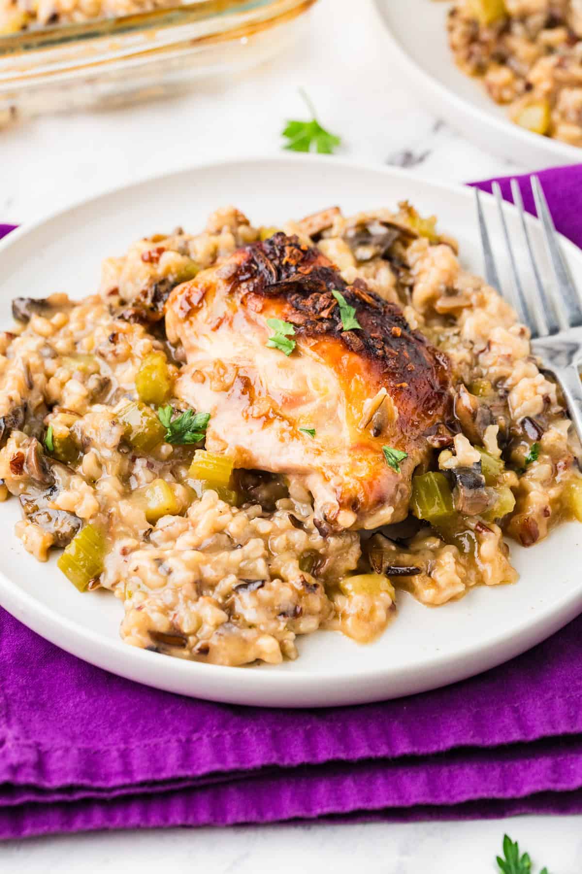 Plate of chicken and rice mixture on a purple placemat.