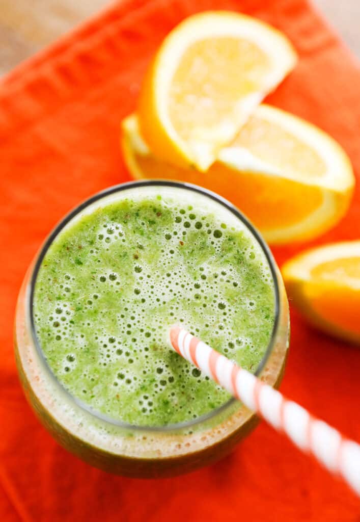 top view of an orange banana smoothie with a straw