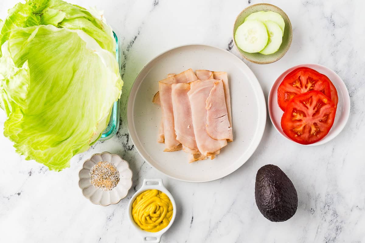 Ingredients to make a homemade jimmy johns unwich lined up on a white counter.
