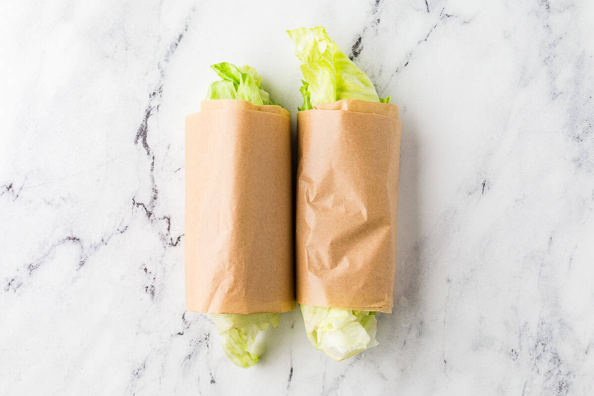 Lettuce wrapped up like a burrito in parchment paper.