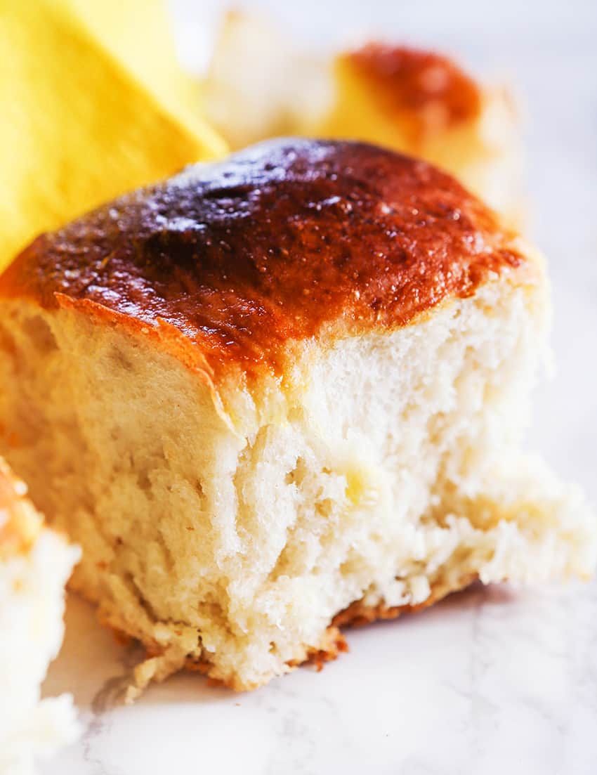 Close up of a fluffy, tall dinner roll.