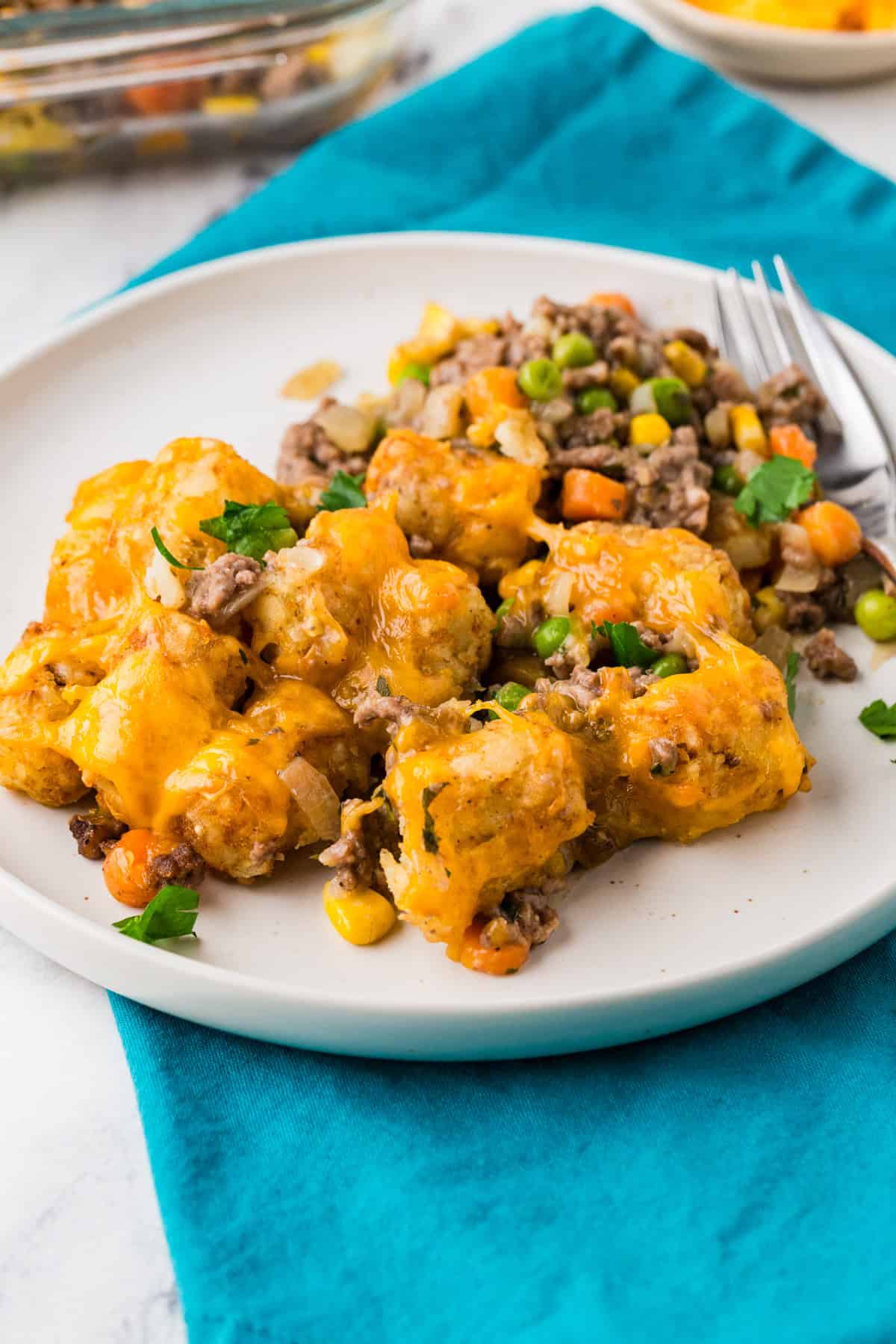 Serving of tater tot casserole on a white plate.