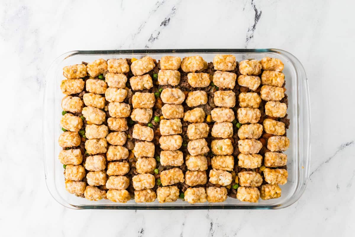 Frozen tater tots in a single layer over a meaty casserole.