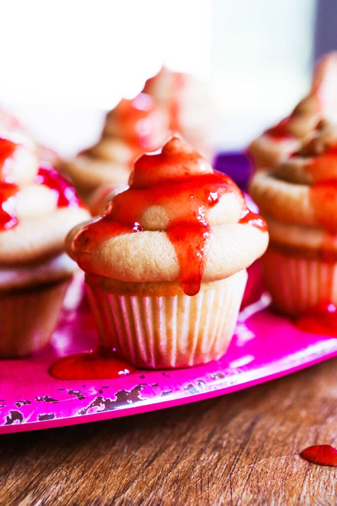 PBJ cupcakes on a plate with jelly dripping down sides.