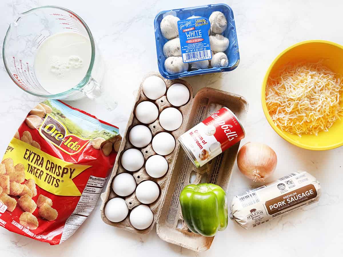 Ingredients for sausage breakfast casserole on a white counter.