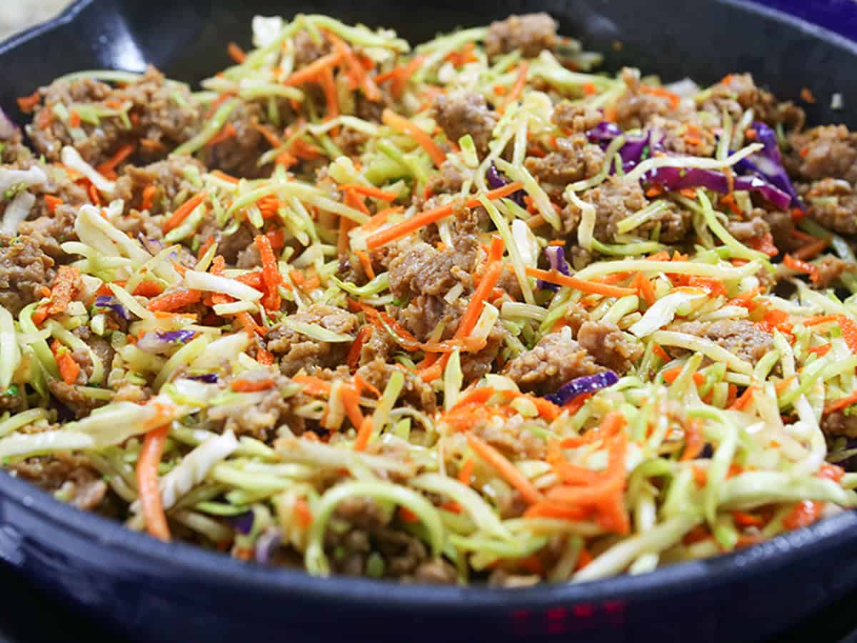 Healthy egg roll in a bowl with shredded cabbage and carrots.