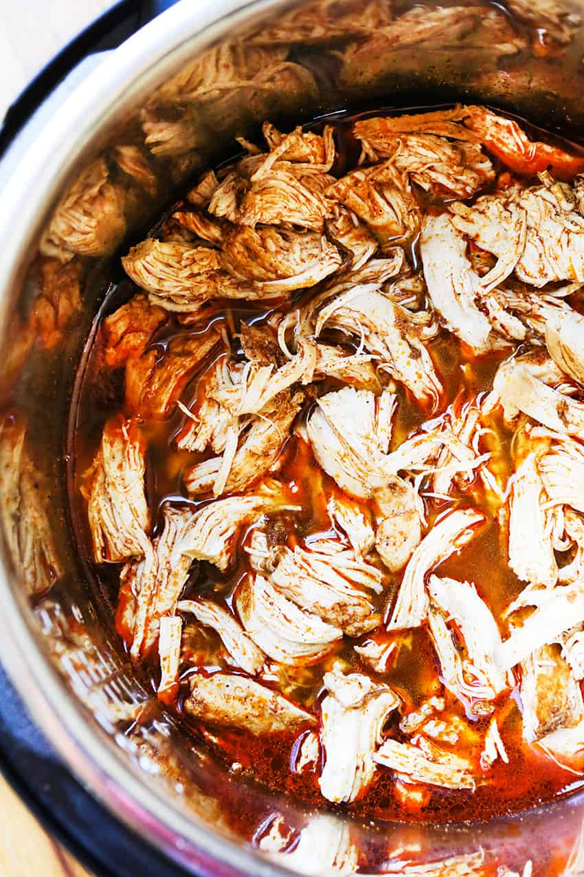 Seasoned shredded chicken tacos inside the instant pot. 