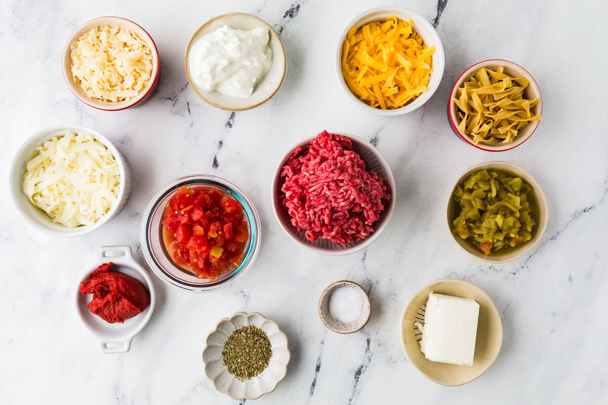 Ingredients for ground beef casserole on a white counter.