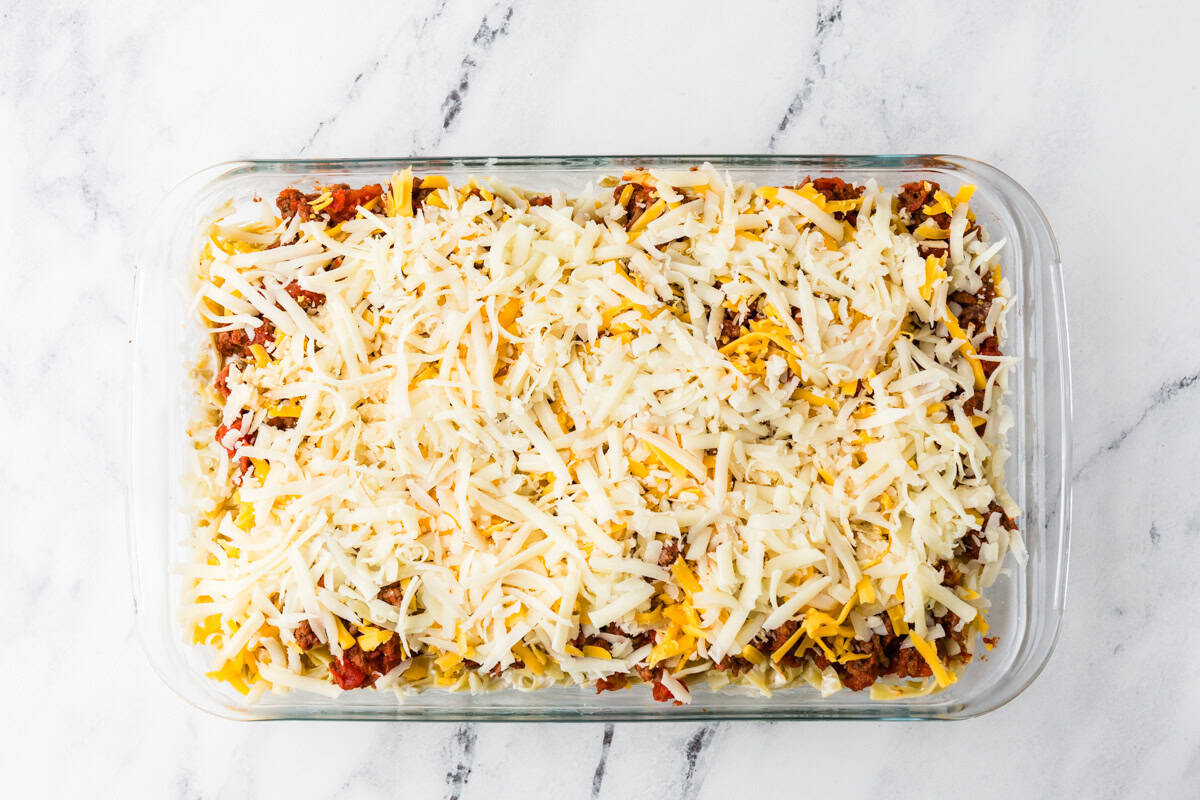 Top view of an assembled pan filled with casserole ingredients.