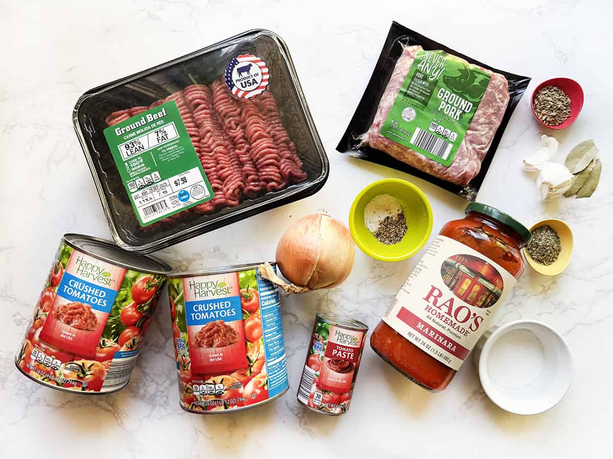 Ingredients for instant pot pasta sauce lined up on a white counter.