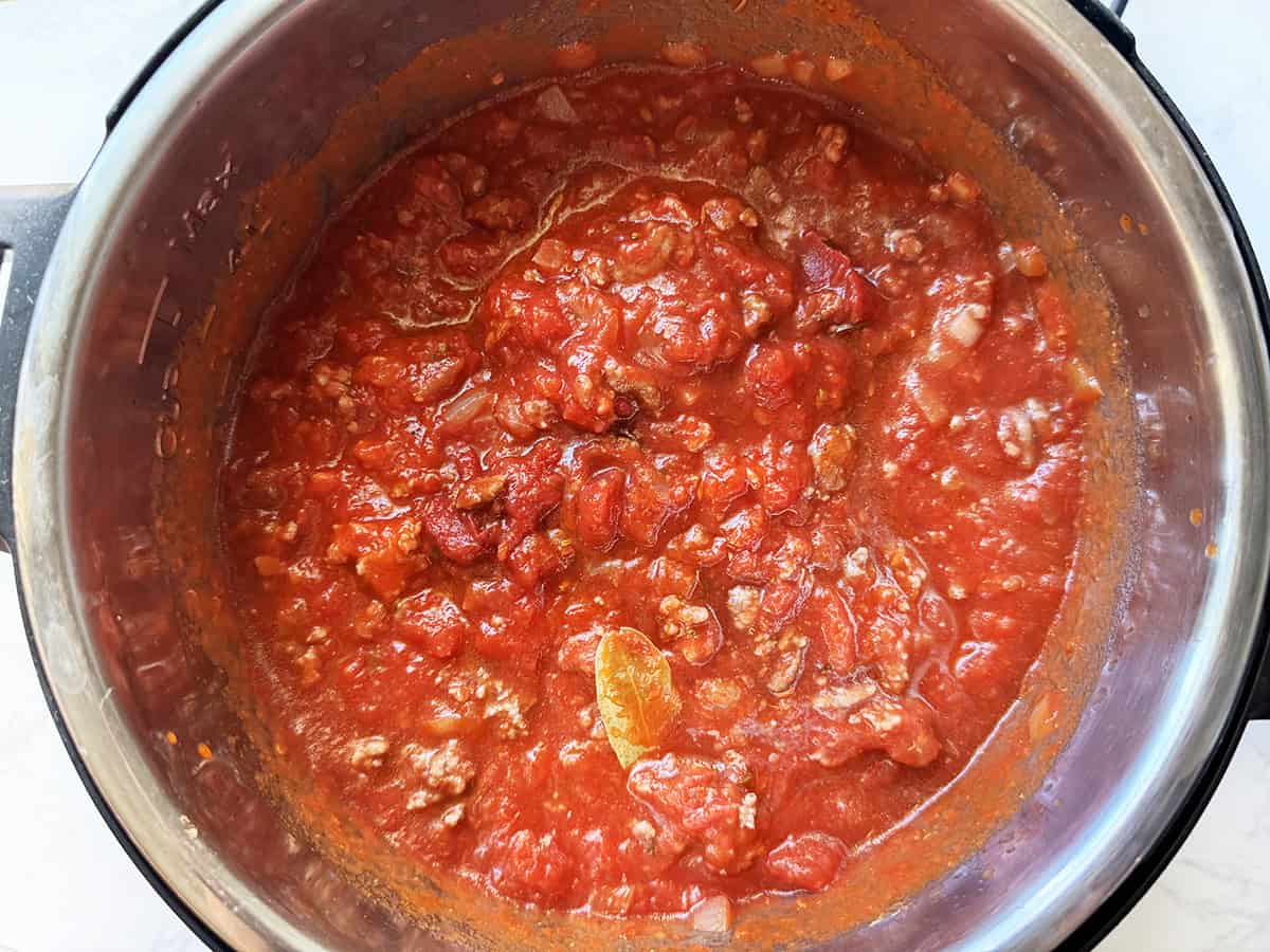 Looking down into an Instant Pot filled with a meaty pasta sauce.