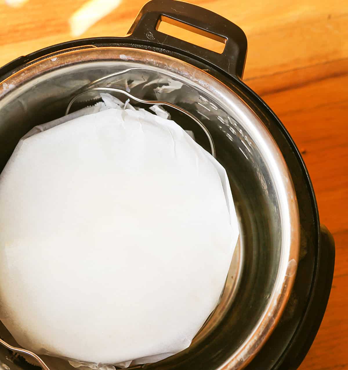 Ice cream maker with fresh ice cream mixture inside, ready to churn for homemade ice cream.