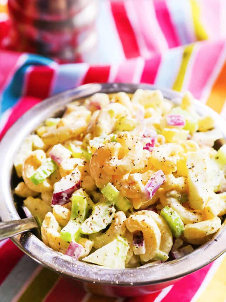 single serving of macaroni salad in a silver bowl