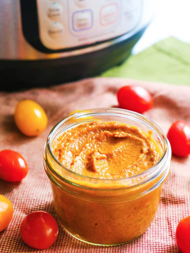 Jar of tomato sauce next to Instant Pot