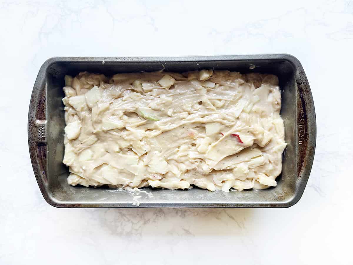 Batter for apple bread in a loaf pan, ready to bake.