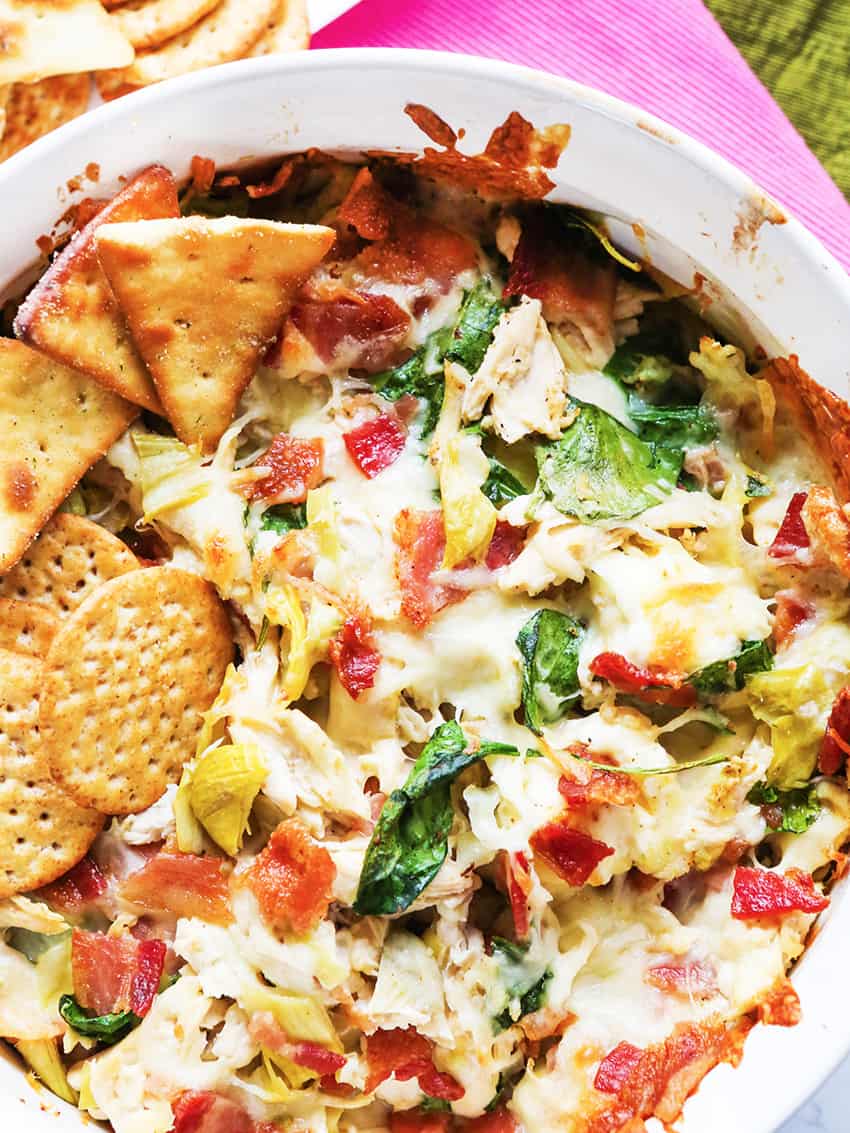 Baking dish of chicken bacon artichoke dip. 