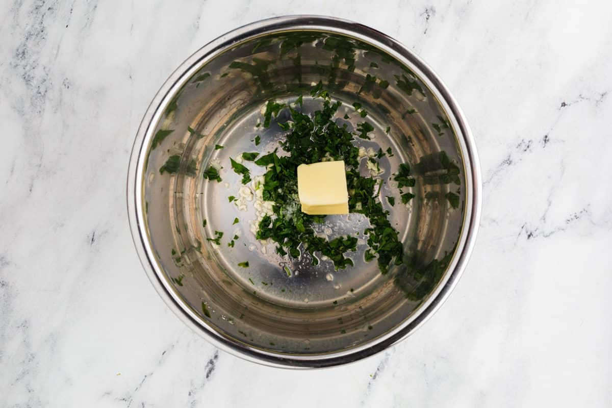 Parsley and butter in an instant pot ready to saute.