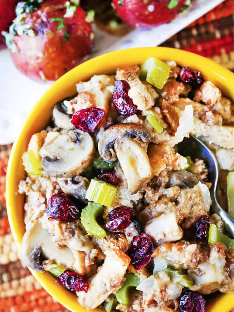 a serving spoon inside a serving bowl of instant pot stuffing