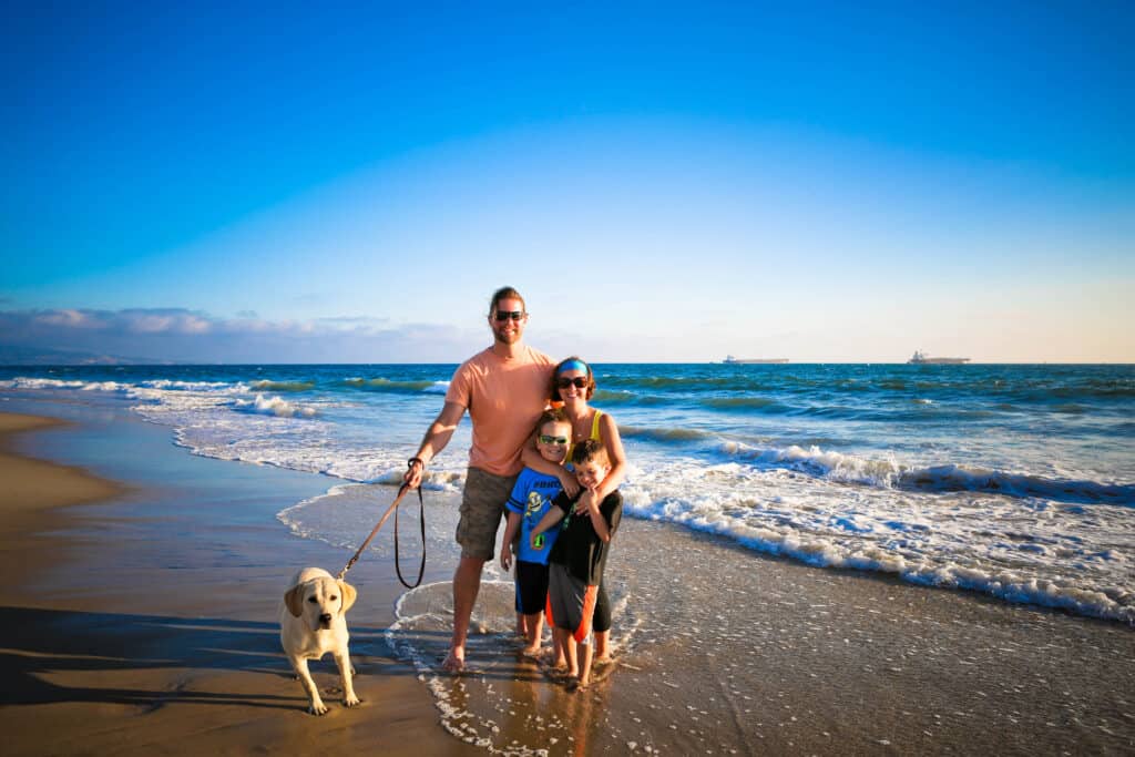 My family and dog standing by the ocean.