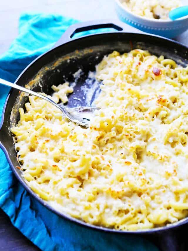 Skilled of cauliflower mac and cheese with a serving spoon resting in it. 