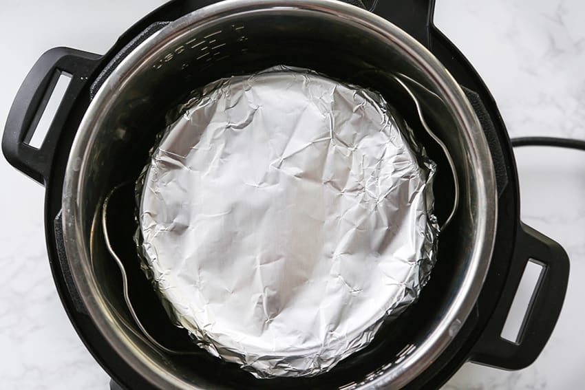 Cake pan covered in foil sitting inside Instant Pot