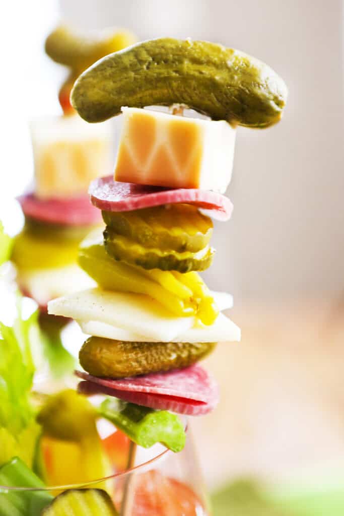 pickle, cheese and other condiments stabbed on skewer