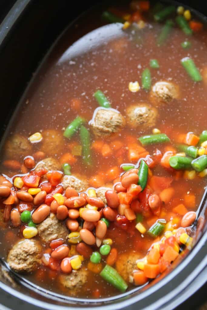 crockpot filled with meatball soup ingredients