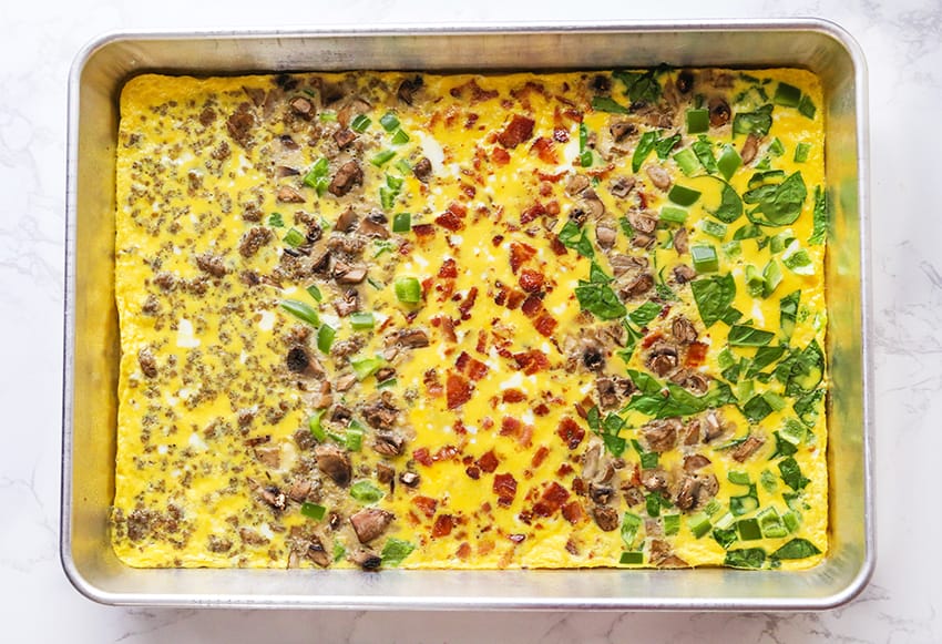 Eggs baked in sheet pan with a variety of toppings