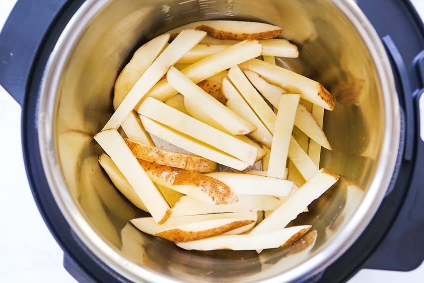 potato strips in bottom of an air fryer