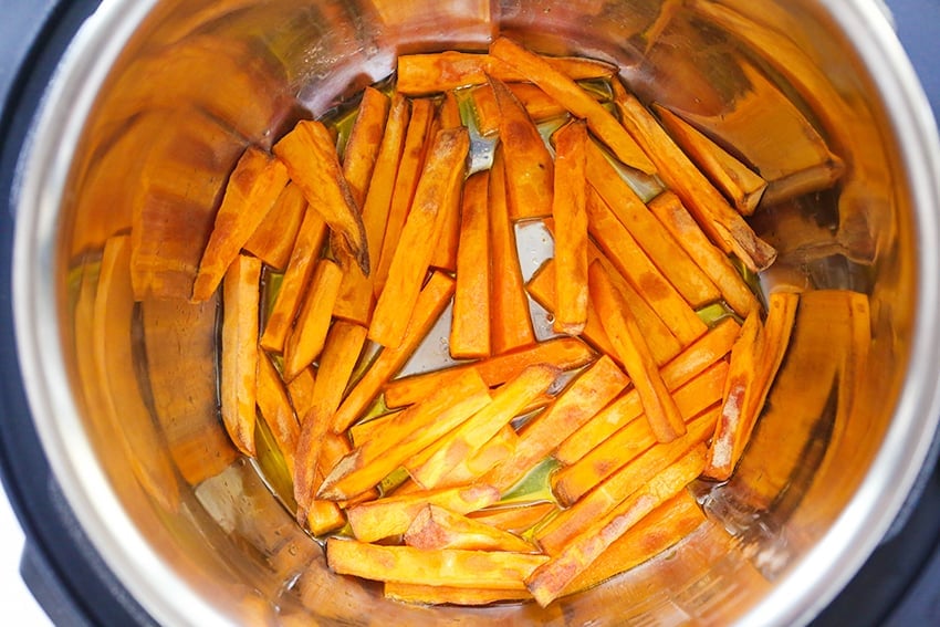 cooked sweet potato fries in bottom of air fryer