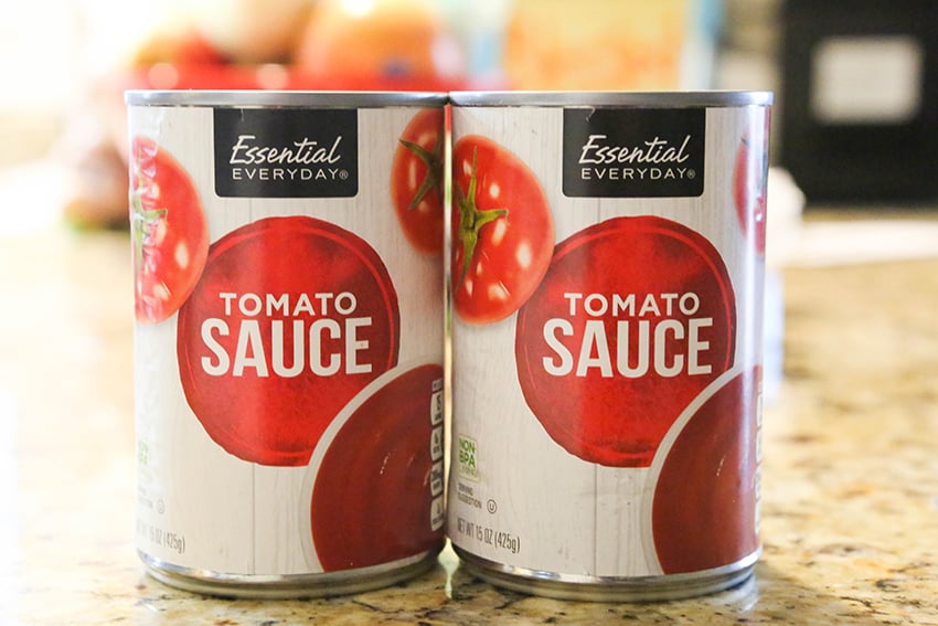 two cans of tomato sauce sitting side by side