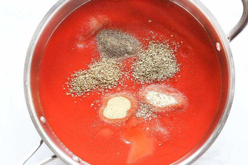 top view of skillet with tomato sauce and spices ready to cook