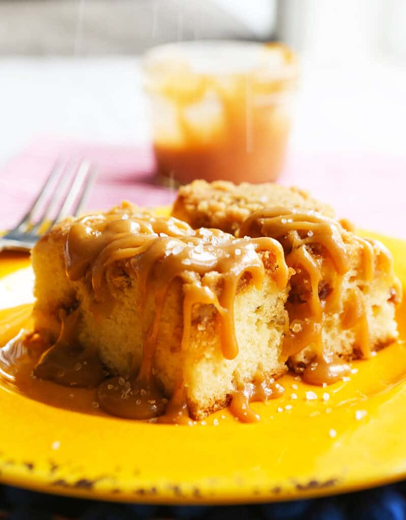 salted being sprinkled over caramel-covered breakfast pastry