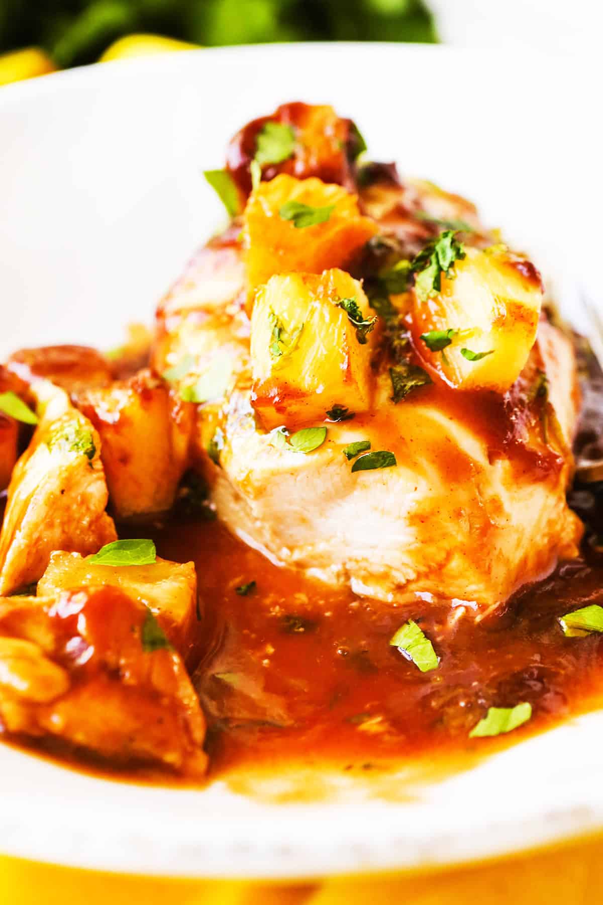 Cooked chicken breast topped with pineapple and bbq sauce.