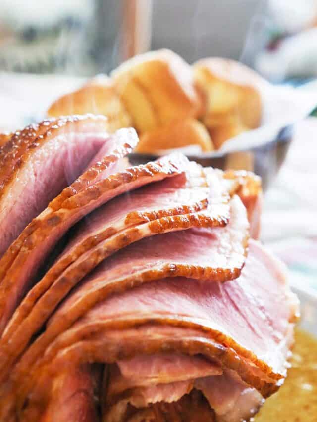 Slices of crockpot ham served on a platter. 