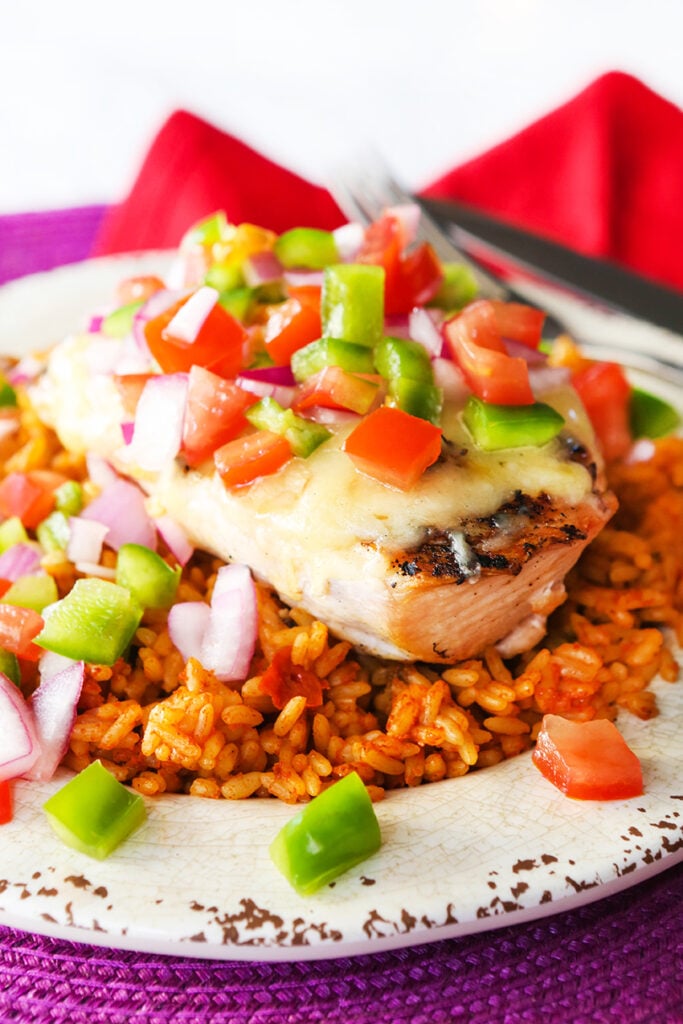 Fiesta lime chicken topped with fresh salsa on a plate