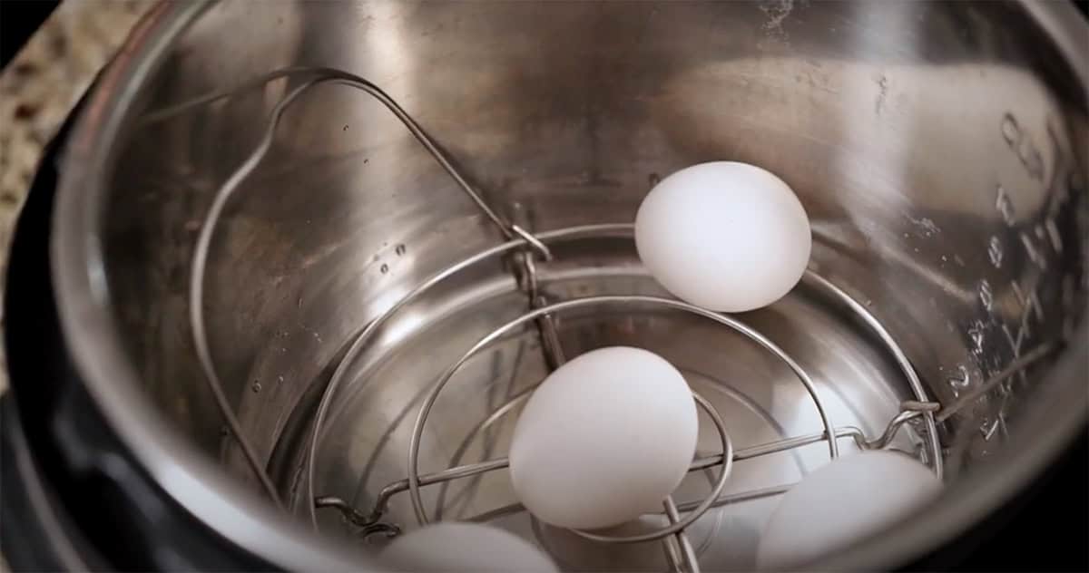 Eggs sitting on a trivet inside an Instant Pot.