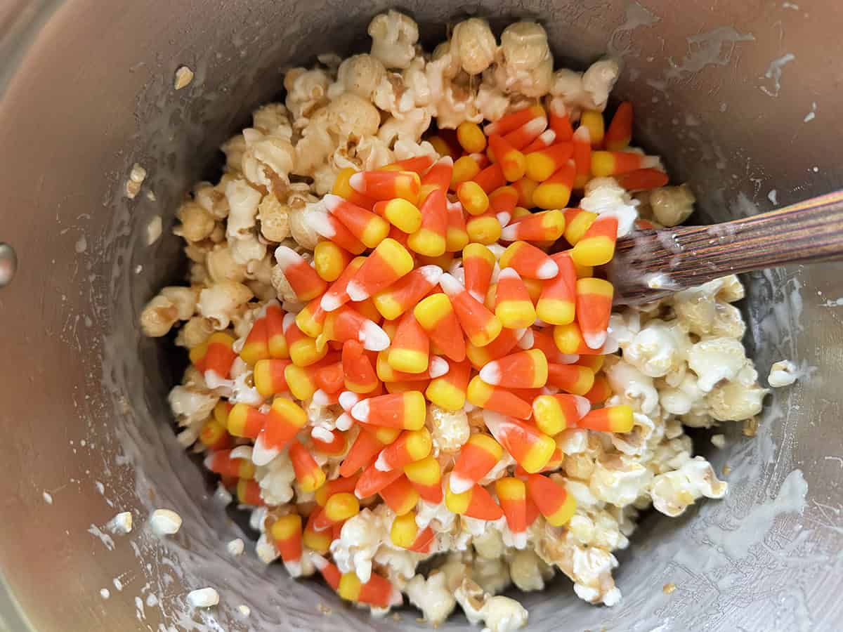 Marshmallow popcorn mixture with candy corn on top.